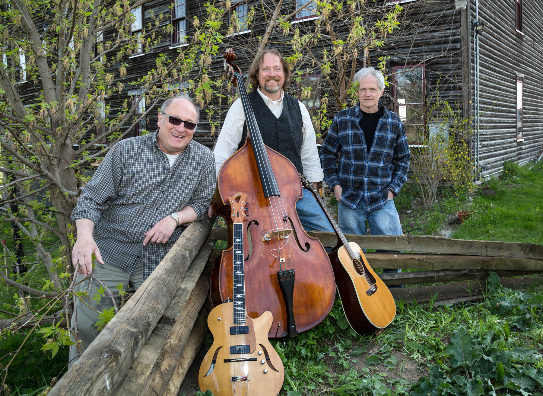 3 Men Seen Outside by a tree with instruments in hand