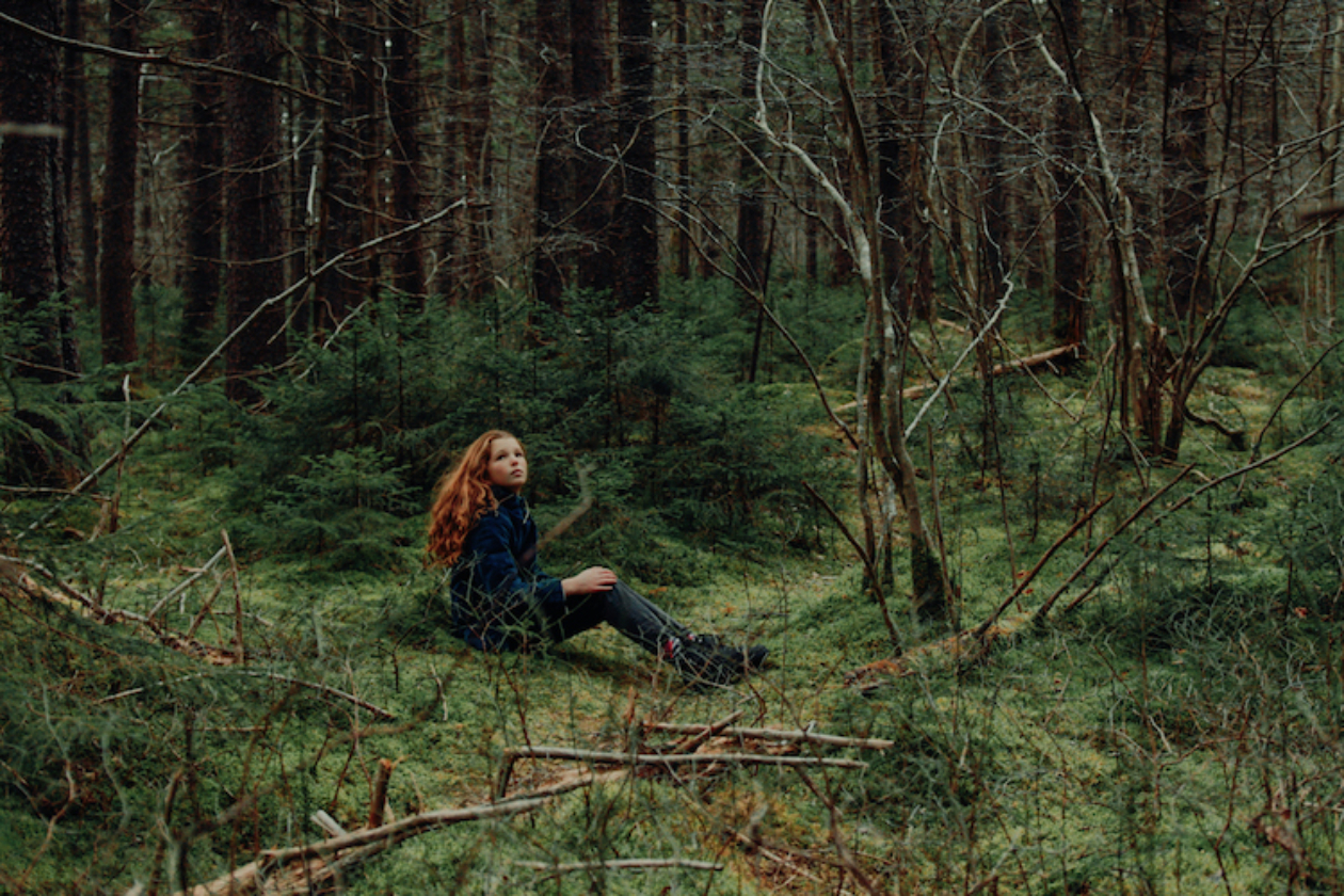 girl sitting in woods