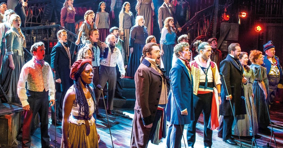 The cast of Les Misérables on stage performing