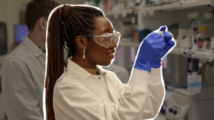 Young black women with safety glasses and lab gear in a science lab