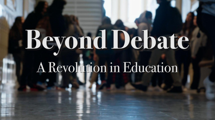 A blurred our photo of students walking down a school hallway with text in white that reads: Beyond Debate: A Revolution in Education