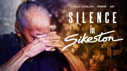 Silence in Sikeston-A photo of a senior with the head bowed covered by folded hands in grief