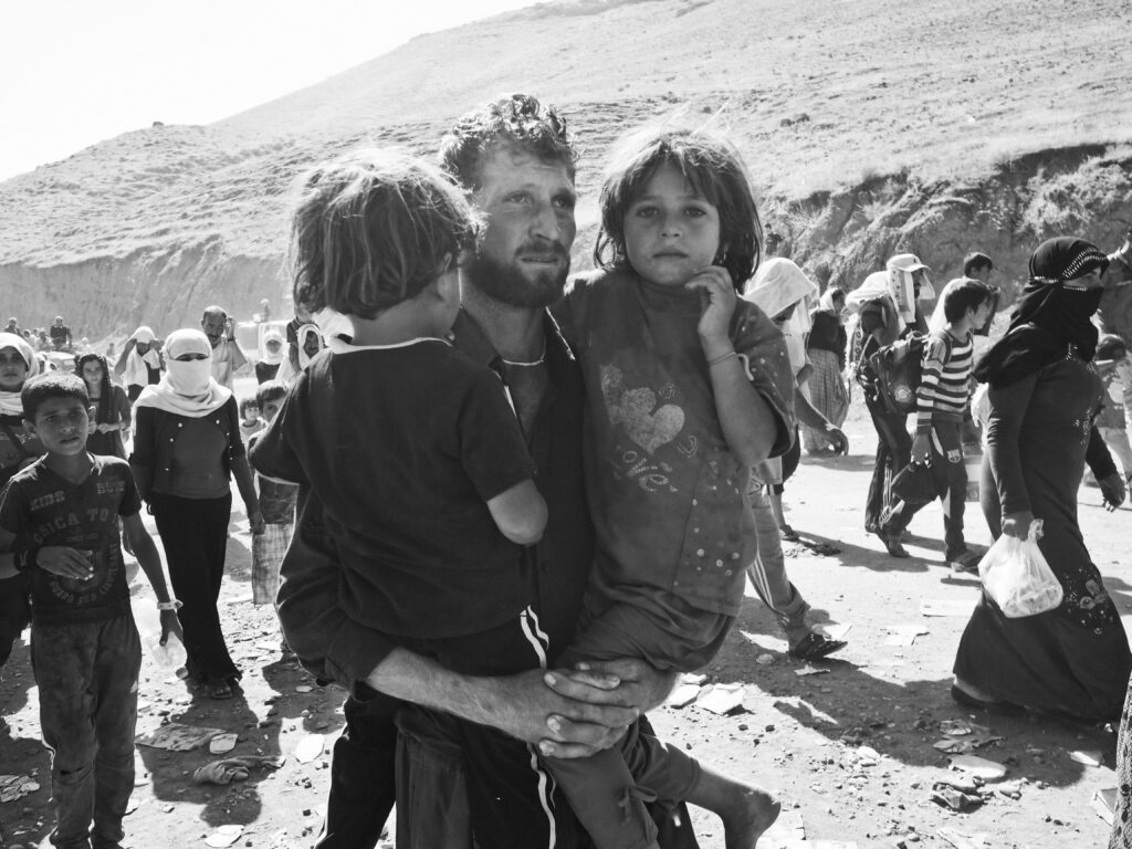 Father and his two children flee the ISIS genocide of the Yazidi people