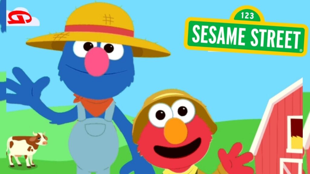 Grover Waves with Elmo as they stand in front of a cow and a barn on their visit a farm in this interactive game