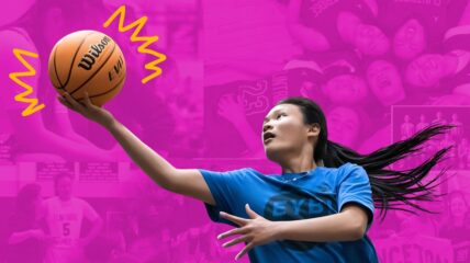 A girl with long Black hair pulled back in a pony tail wearing a blue t-shirt with a basket ball in her hand about to do a lay up.