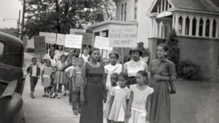 Black mothers and children holding signs