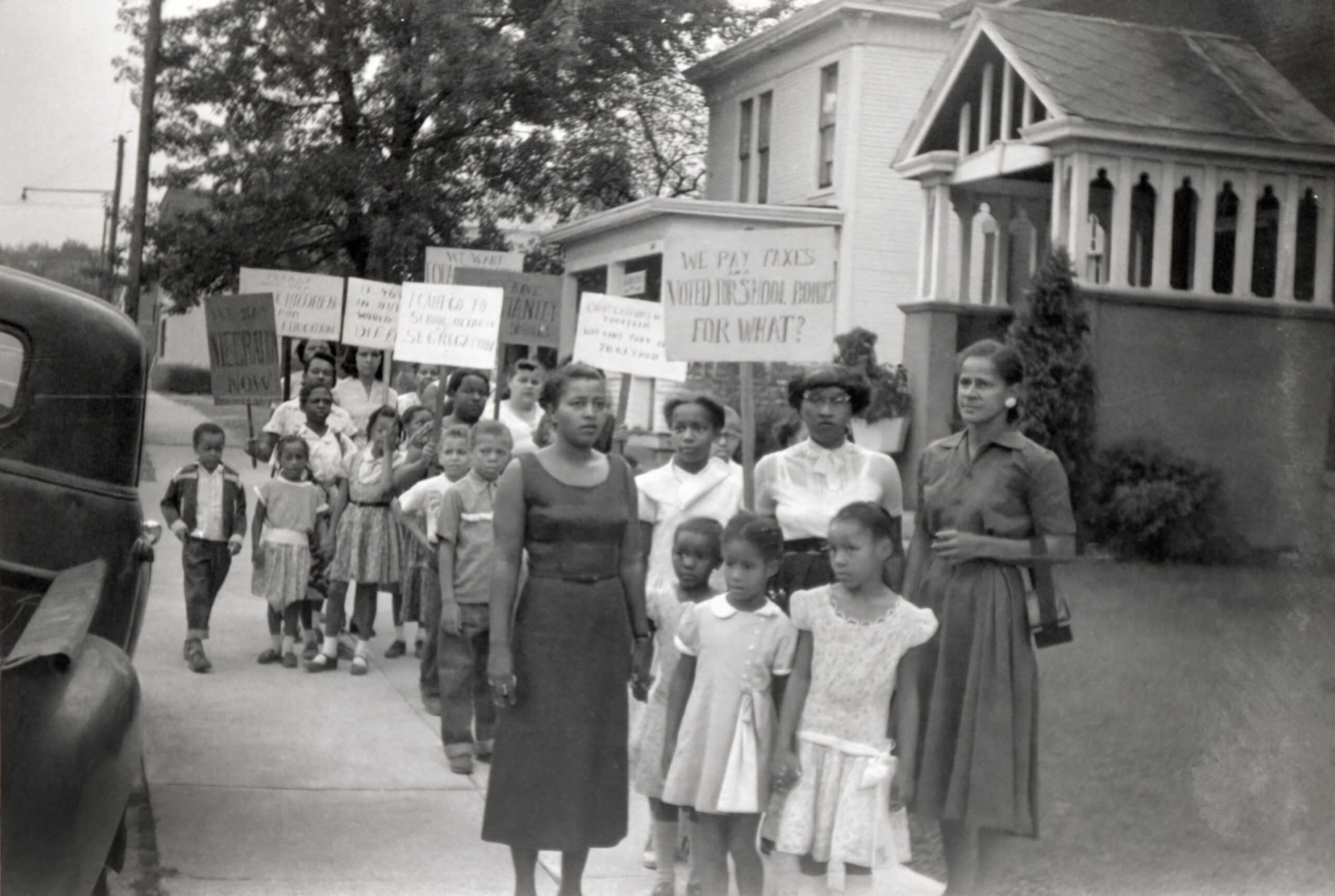 Black mothers and children holding signs