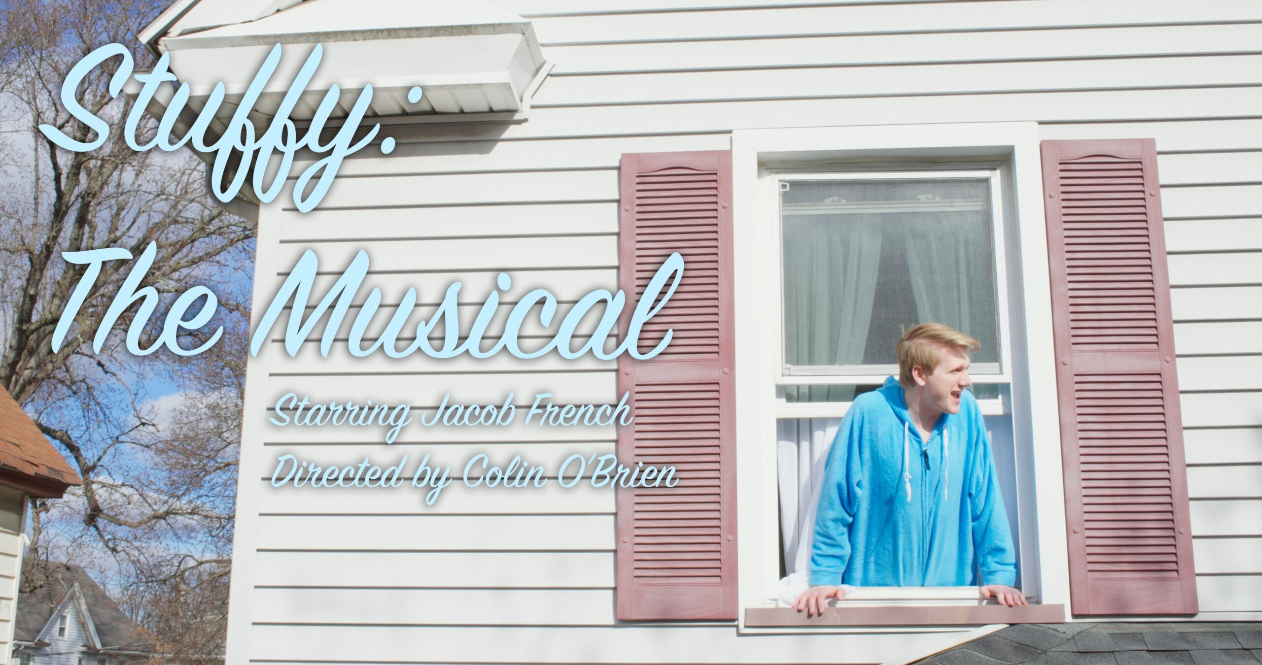 A teenage boy with blonde hair wearing a light blue robe hangs out of an upstairs window.