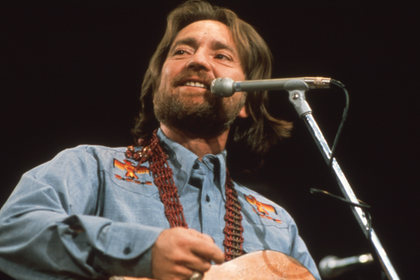 Willie Nelson in 1974 on stage singing