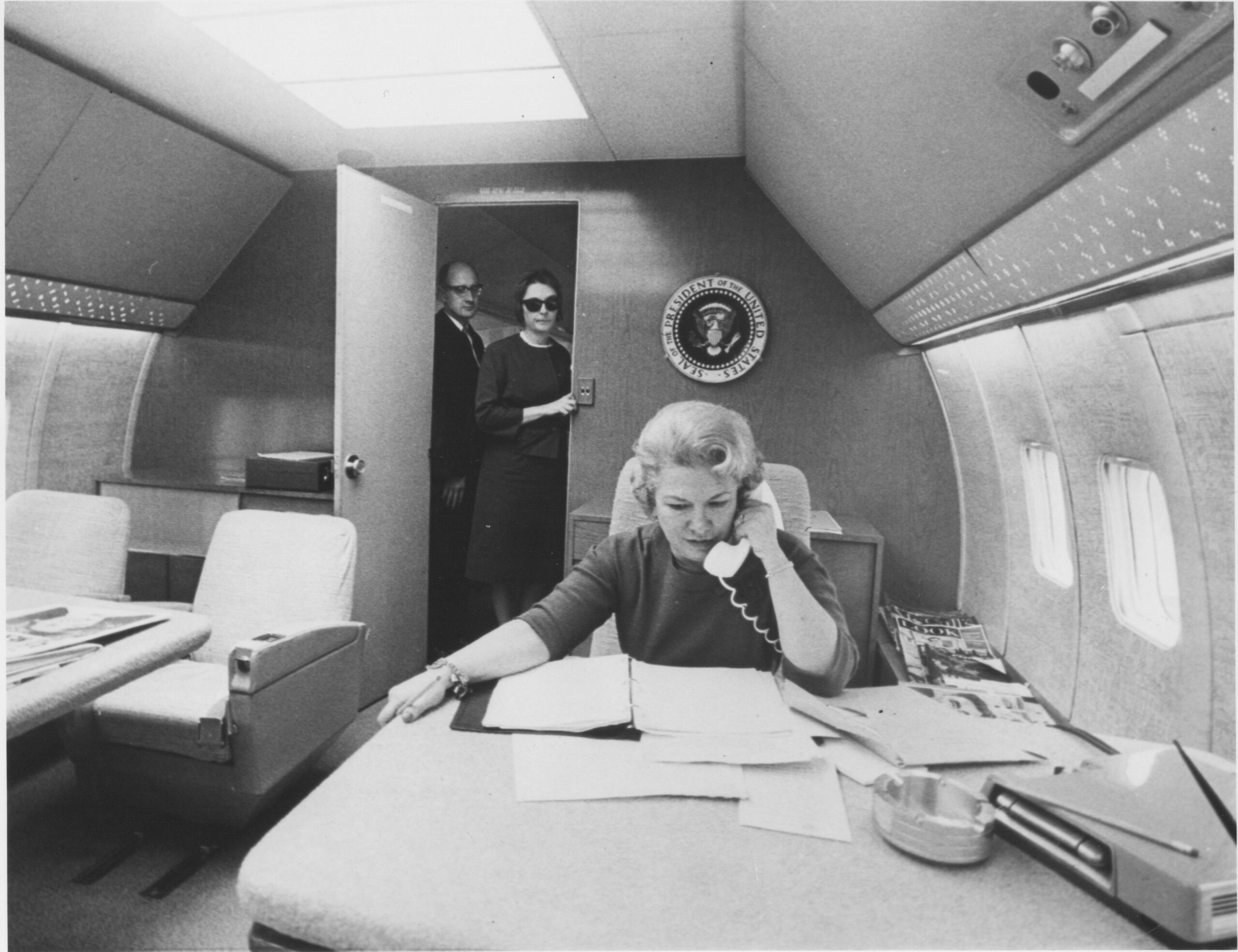 Liz Carpenter on phone on Air Force One